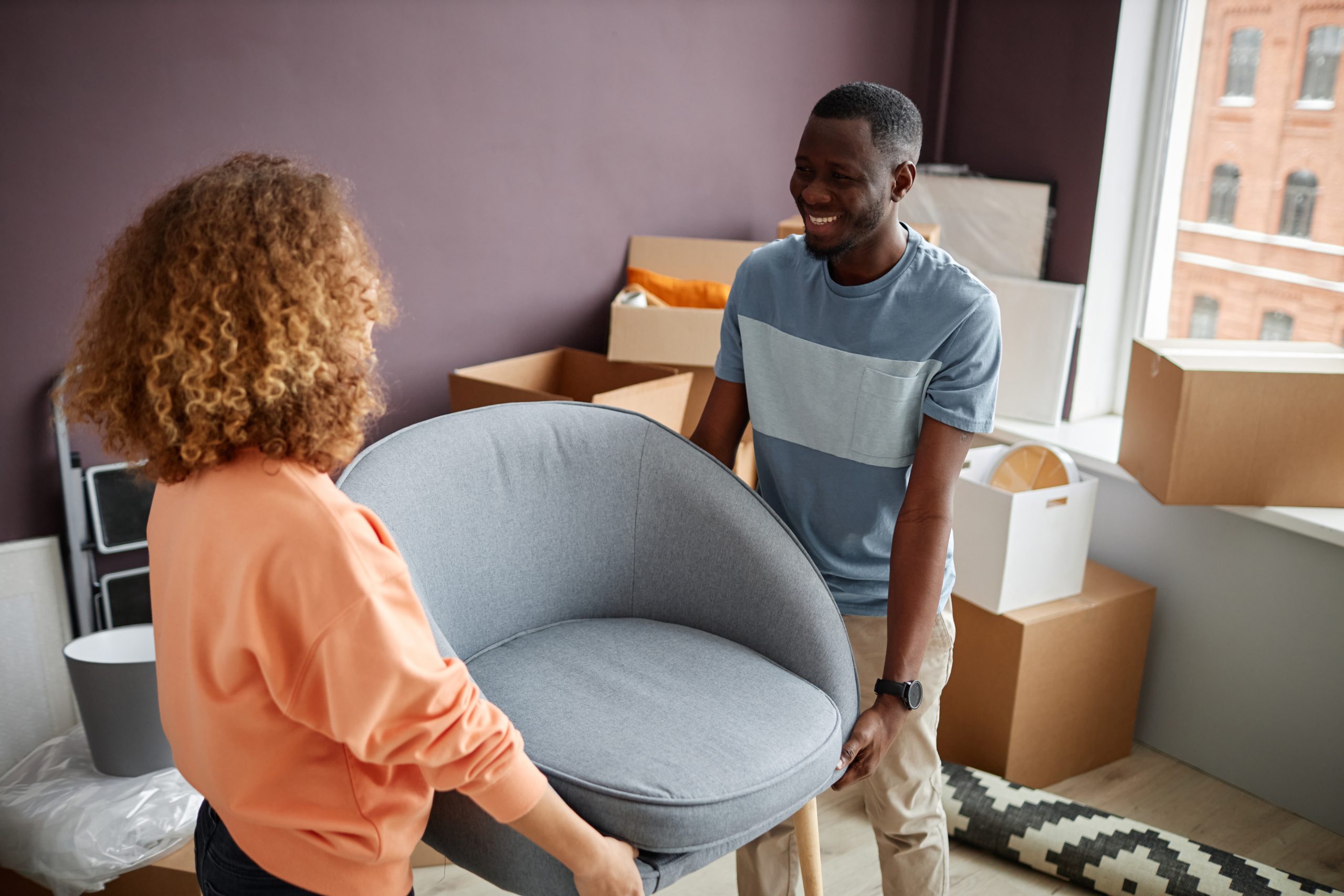 Couple bringing new furniture to apartment